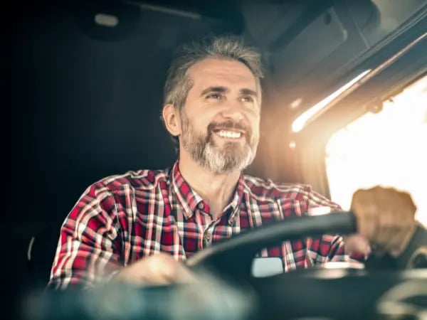 Smiling man driving truck