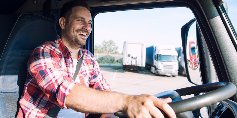 man smiling driving truck